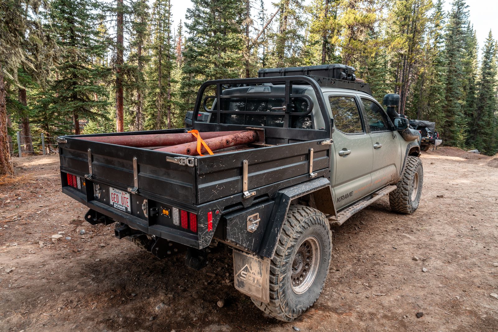 Off-road vehicle with a flatbed in a forest setting