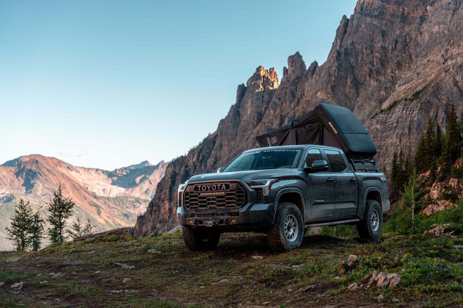 Toyota truck with a iKamper rooftop tent in a mountainous landscape